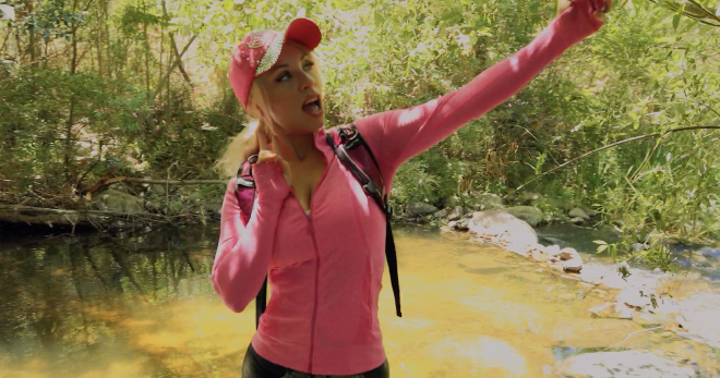 An image of Barbi in the wilderness, taking a selfie with a traditional cute pose.