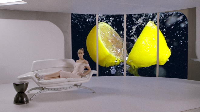 A woman lounges in a dress on a sofa in a room on a space station. Behind her, a juicy, cut in half lemon is superimposed on the viewport into space.